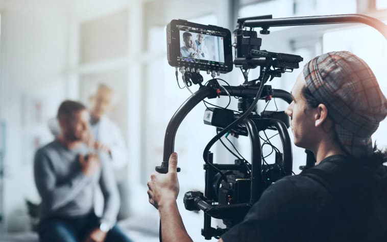 Film crew operating a cinema camera on a production set