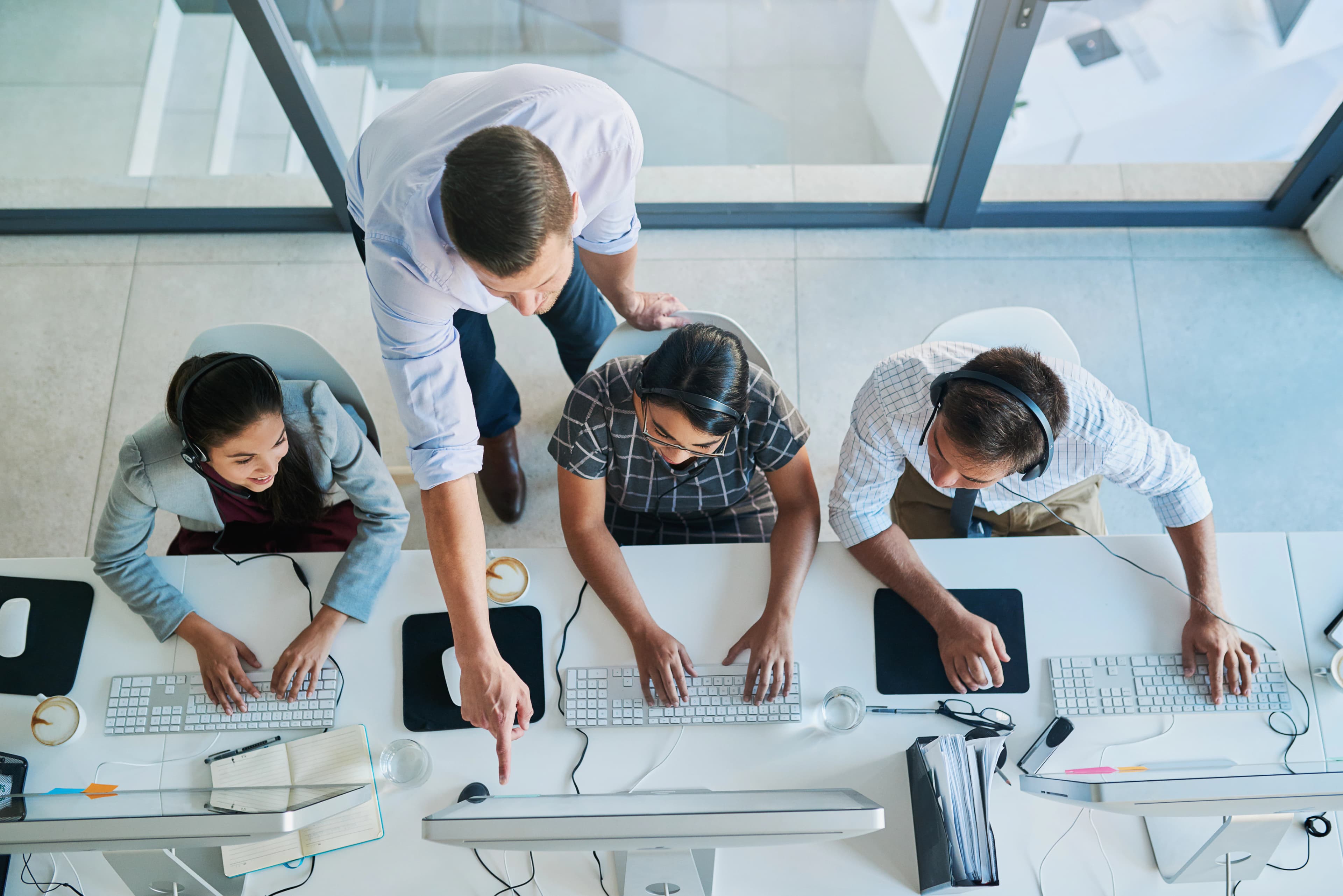 Overhead view of a media planning team collaborating at a desk