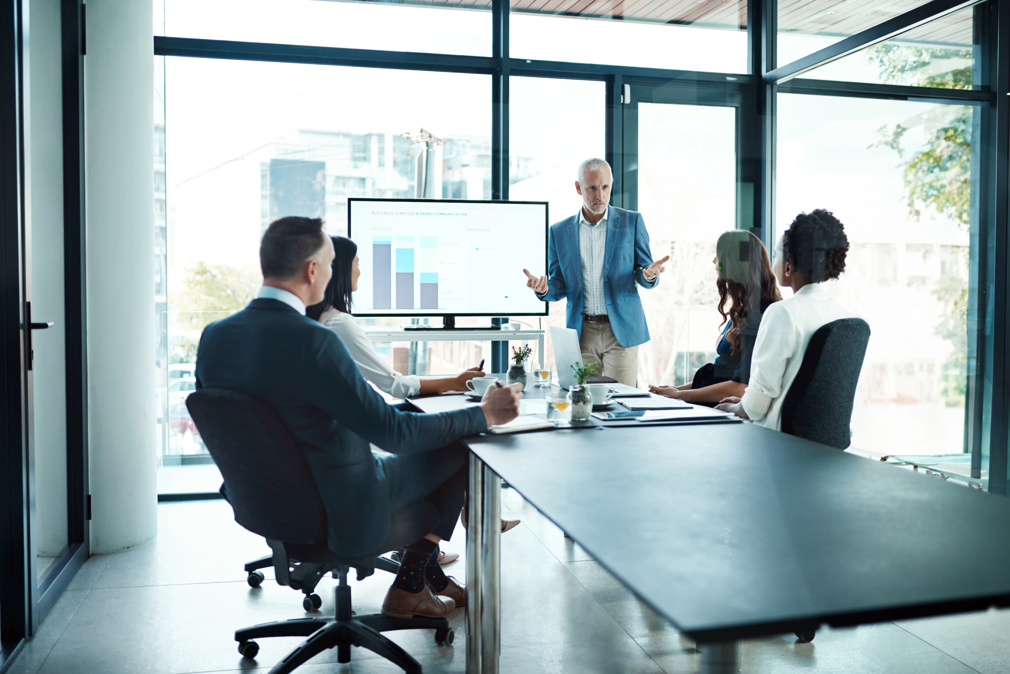 Team reviewing pitch deck assets in a modern conference room
